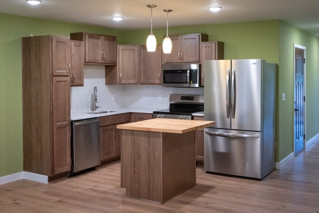 Sixty West open kitchen with island and stainless appliances